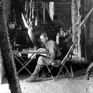 Alfred Percival Maudslay sitting in Tripolina chair, interior of southern chamber, Casa de Monjas at Chichen Itza, 1889